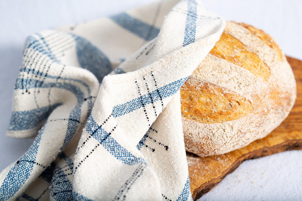 These unique yet functional tea towels are large enough to have multiple uses.  Here, I've used the tea towel as a bread cloth to cover a freshly baked whole wheat and rye sourdough bread loaf.  Image by Second Star Photography, Whitecourt, Alberta.