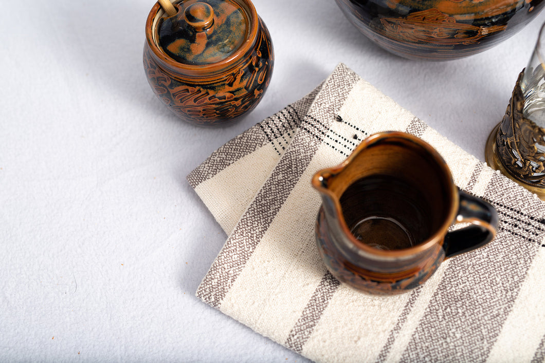 The gray stripes in this unique dish cloth complement the natural unbleached cotton yarn, and is woven together with our cotton bouclé yarn.  The knobby texture is great for removing those stubborn baked-on foods yet soft enough not to scratch even the most delicate china or crystal. 